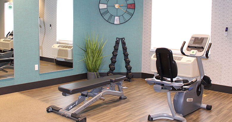 State-of-the-art fitness center at Simple Suites with cardio and strength equipment.