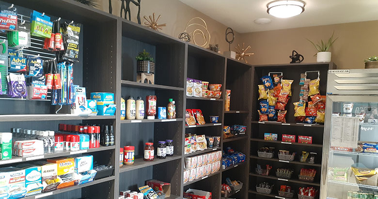 Fully stocked snack store at Simple Suites with chips, beverages, and travel essentials.